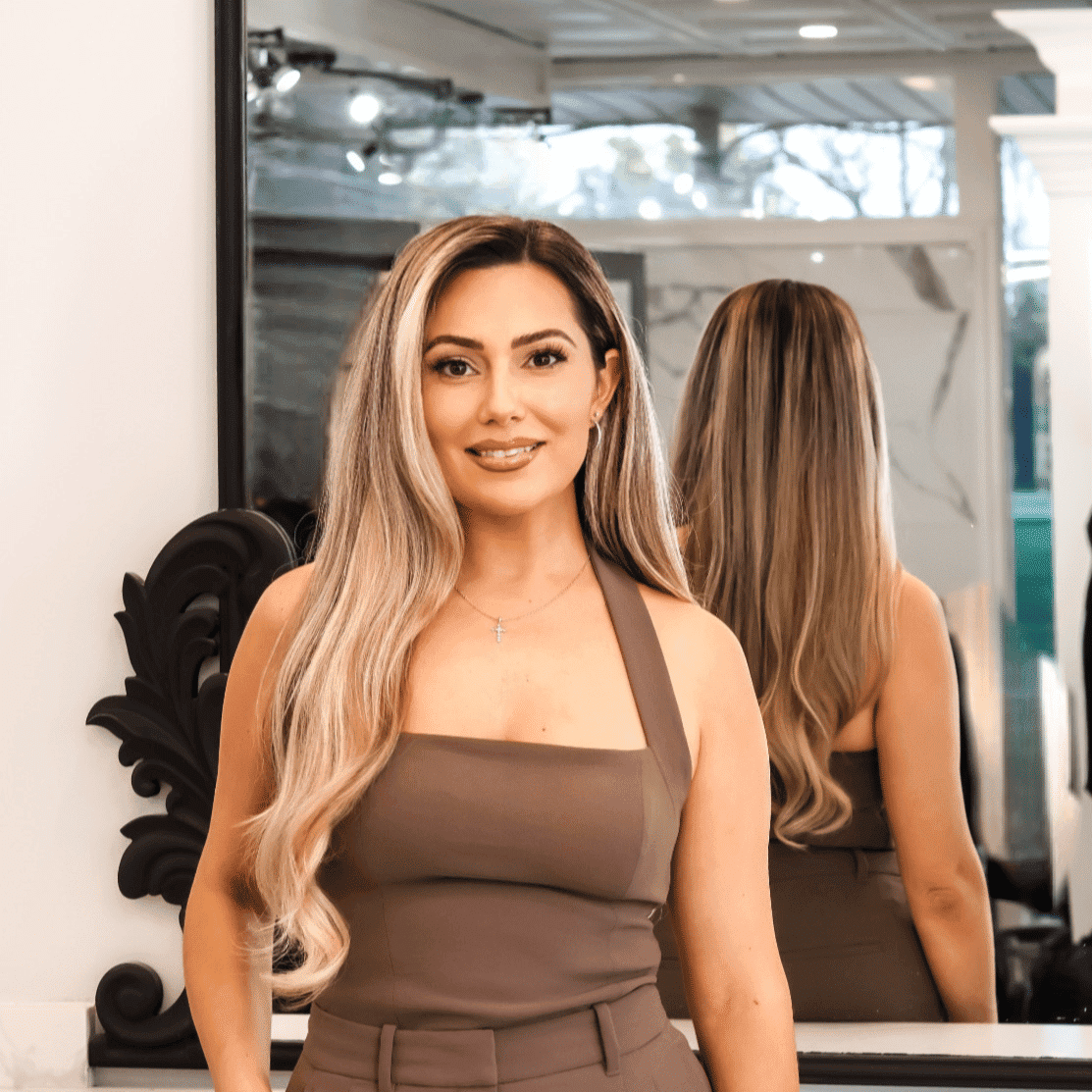Portrait of ANTONETTE KRCAJ, a professional stylist at Runway Salon & Beauty Bar, showcasing their expertise and style.