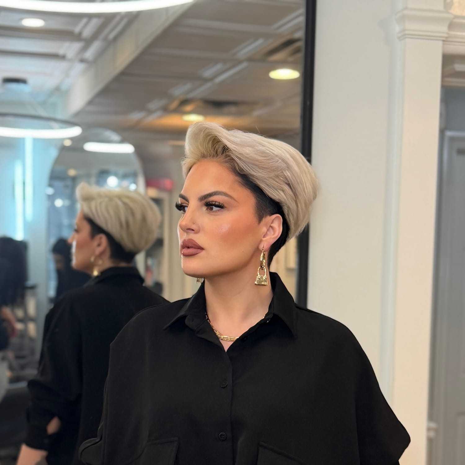 Portrait of DORI COLLAKU, a professional stylist at Runway Salon & Beauty Bar, showcasing their expertise and style.